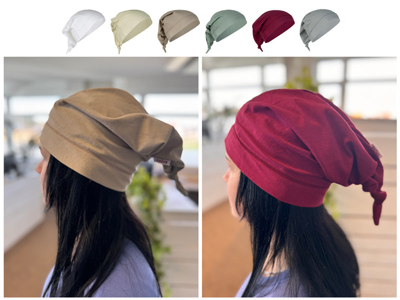 Fotomontage mit einer beiger und roter Beanie-Zipfel-M�tze auf dem Kopf eines Maedchens. Darueber eine Reihe mit Zipfelmuetzen in den Uni-Farben Weiss, Hellbeige, Beige, Gruen, Dunkelrot und Silber-Grau.