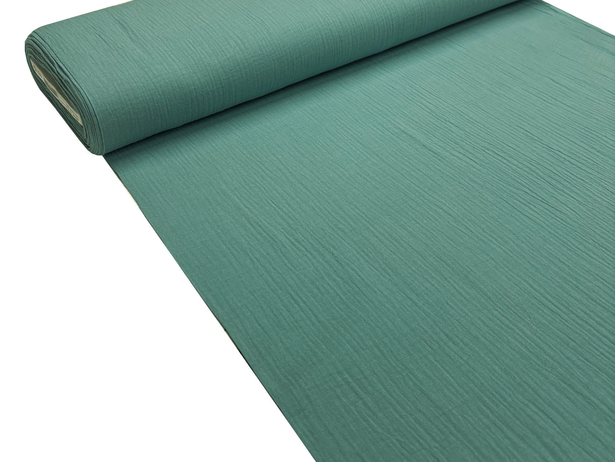 Musselin Stoffrolle in petrol-grün.