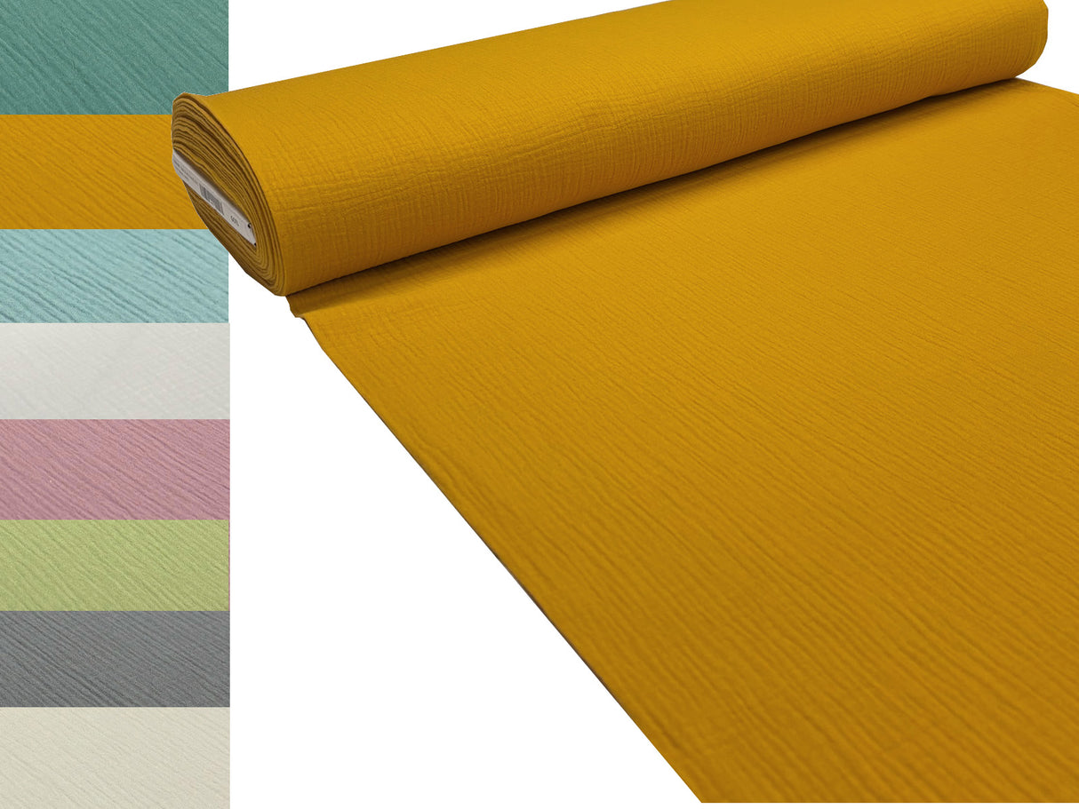 Musselin Stoffrolle in senf-gelb. Daneben sind die Farben petrol-gruen, senf-gelb, tuerkis, weiss, mauve, gruen, anthrazit und natur abgebildet.