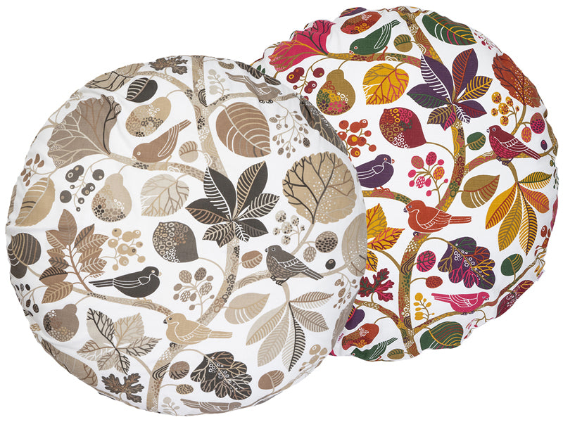 Zwei runde Kissenbezuege mit Blaetter, Zweigen und Voegeln auf weissem Hintergrund bedruckt. Einer ist in den Farben braun/taupe und der andere ist ganz bunt gehalten.