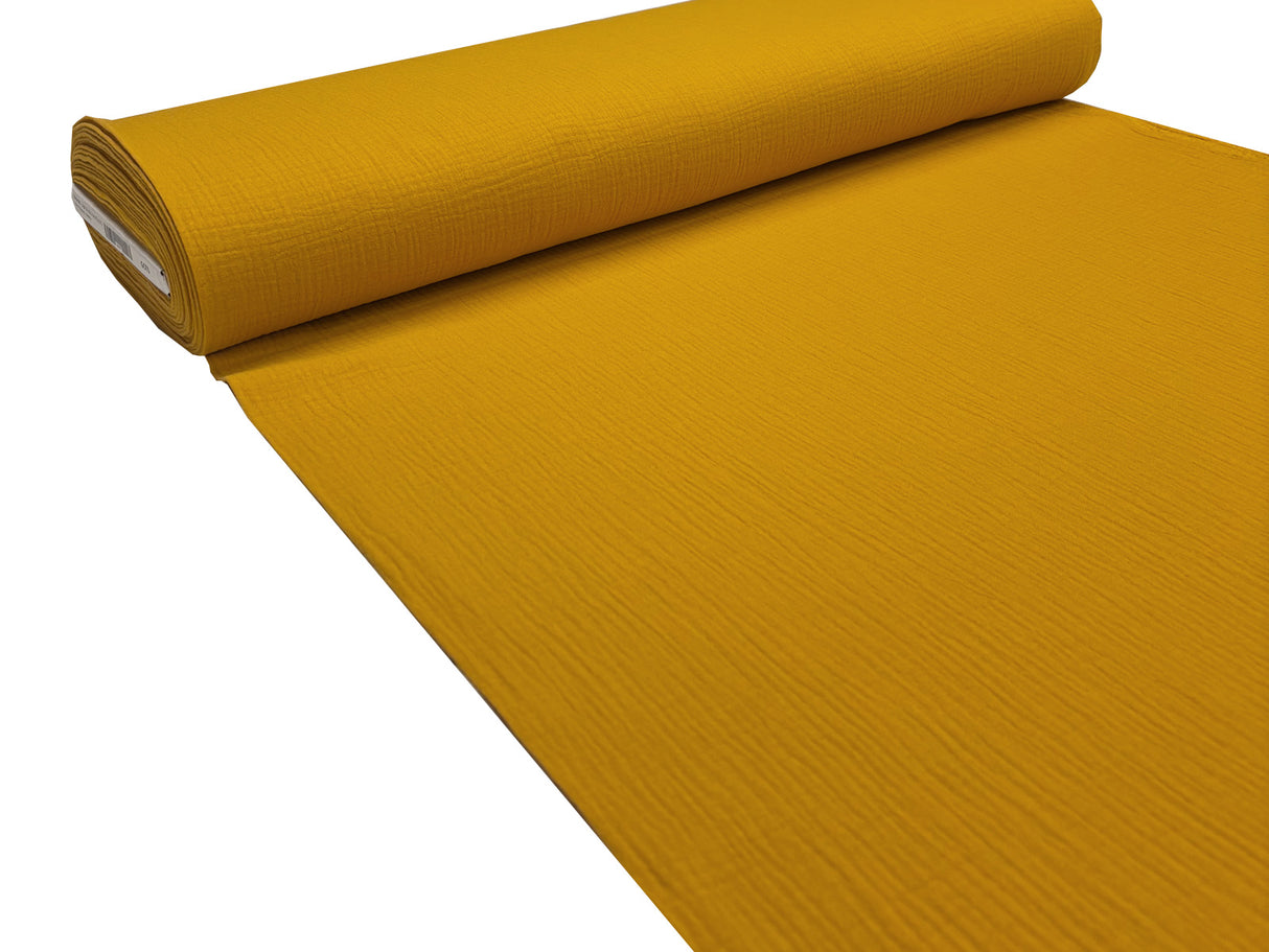 Musselin Stoffrolle in senf-gelb.