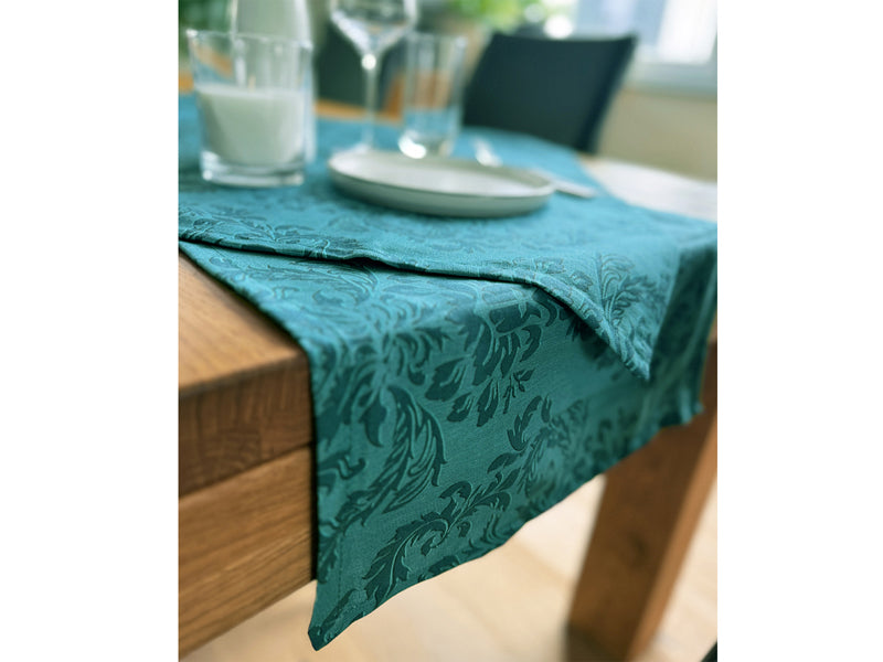 Petrolfarbener Tischlaeufer, bedruckt mit barocken Ornamenten in einem dunkleren Petrol.